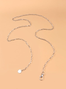 Close-up of silver alloy body chain featuring a lobster clasp and smooth round disc pendant