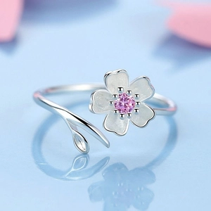 Pink cherry blossom adjustable open ring with white petals on light blue background
