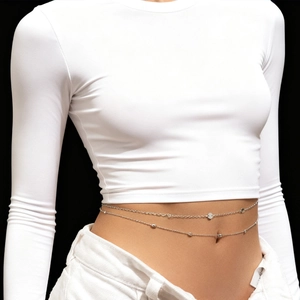 Detail view of silver double-layered body chain with metallic sequins and beads on model