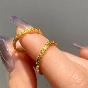 Detailed close-up of golden hammered ring with sparkling faceted light reflection