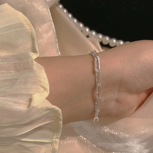 Close-up of double layer silver bracelet with hammered texture on female wrist