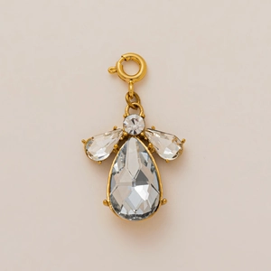 Detail of angel pendant with 18K gold plating and pear-shaped clear crystals