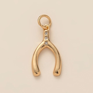 Gold plated stainless steel wishbone pendant with three sparkling crystal accents