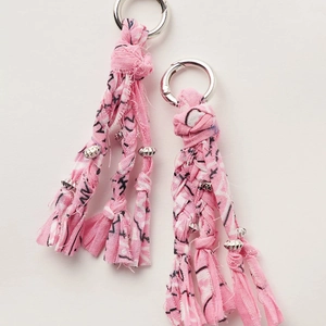 Pink handmade woven fabric tassel keychain with metal beads and silver spring rings
