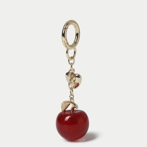 Detail of red glitter cherry pendant with gold leaf heart and metallic ring clasp