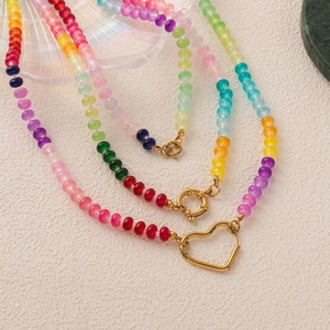 Detailed macro of colorful beaded necklace with golden heart clasp and spring ring