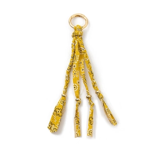 Detail of yellow paisley bandana keychain with golden beads and round spring buckle