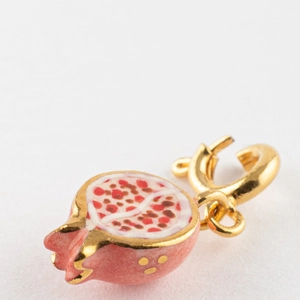 Détail d'un pendentif grenade plaqué or 18K avec émail rouge réaliste et fermoir doré