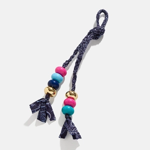 Detailed close-up of handmade evil eye charm with blue tassels and colorful beads