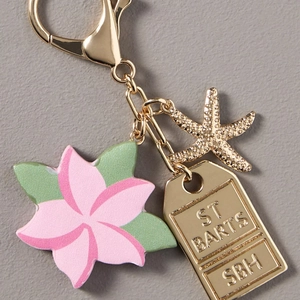Detail of St Barts keychain with frangipani flower and star pendant on lobster clasp