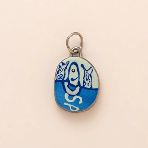 Artistic enamel pendant with blue smiley face design and silver loop in minimalist style