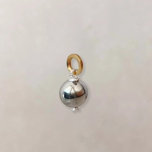 Detail showing two-tone sphere pendant with silver mirror finish and gold ring connector