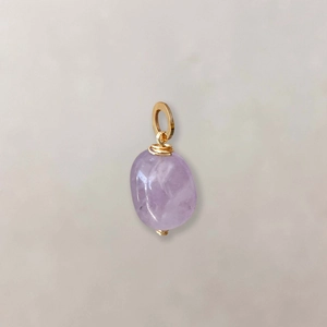 Detail of a light purple irregular amethyst pendant with gold wire wrapping