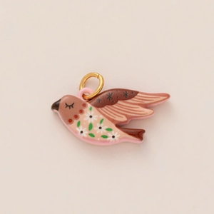 Exquisite pink bird charm pendant with white floral hand-painted details in 14K gold finish
