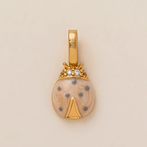 Detailed view of ladybug pendant with beige enamel shell and gold-plated hardware