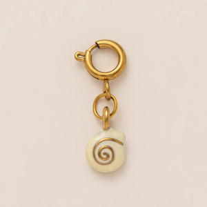 Macro shot of gold spiral shell pendant with matte metallic loop for DIY jewelry making