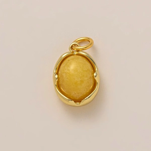 18K gold plated oval yellow gemstone pendant with rounded hoop on beige background