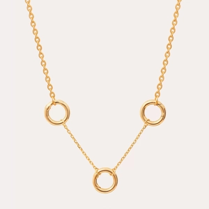 Detail of 18K gold plated necklace featuring three polished decorative rings on a fine chain