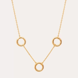 Detailed macro view of 18K gold-plated circular spring clasps on a dainty link chain
