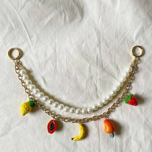 Détail du porte-clés double couche plaqué or 14K avec perles et breloques de fruits