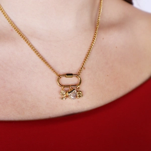 18K gold plated necklace with rose, heart crystal, and letter B charms on model