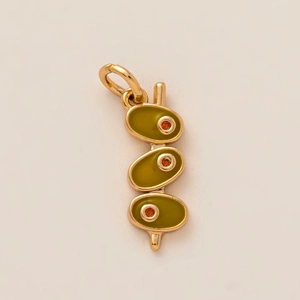 Detailed view of cocktail olive charm with green enamel and orange zircon stone in 18K gold
