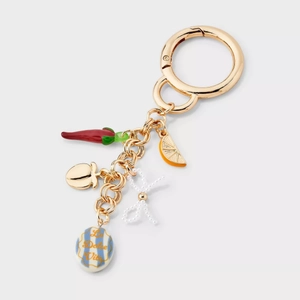 Detailed 18K gold keychain with lemon charm, chili pendant, and La Dolce Vita ceramic tag