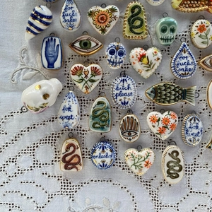 Colgantes de cerámica pintados a mano con diseños de corazón, serpiente y flores