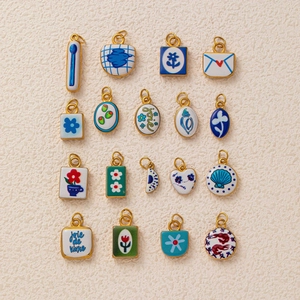 Detailed collection of 18k gold plated enamel flower and shell charms with French motifs