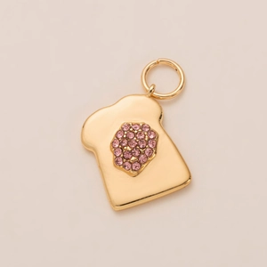 Detailed close-up of a gold-plated toast pendant with sparkling pink zircon inlays