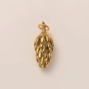 Macro shot of 18K gold-plated stainless steel pine cone pendant with layered 3D details