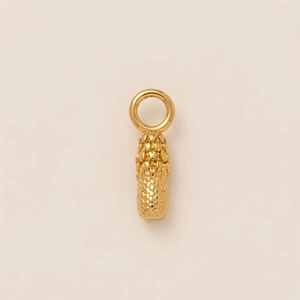 Close-up of 18K gold plated cylindrical pendant with textured pineapple scale patterns