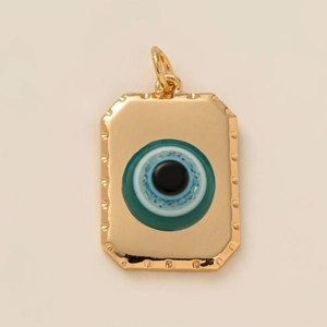 Detailed close-up of golden rectangular Evil Eye pendant with blue inlay and glitter accents