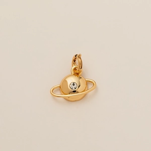 Detailed macro view of a gold-plated Saturn planet pendant featuring a sparkling clear zircon