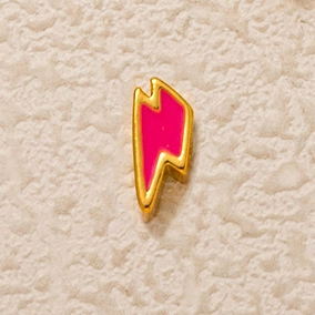 Vue détaillée d'un pendentif éclair avec placage doré et finition en émail rose vif