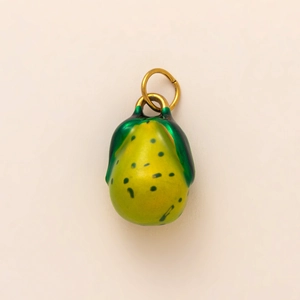 Detailed view of yellow and green pear-shaped jewelry pendant with golden metal ring