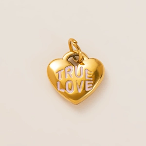 Detailed view of a gold puffed heart charm featuring pink True Love engraved lettering