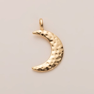 Close-up of a gold-plated crescent moon pendant featuring a unique hammered metal texture