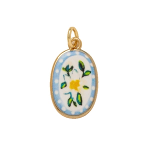 Floral oval pendant necklace featuring yellow flowers and blue polka dots on white enamel
