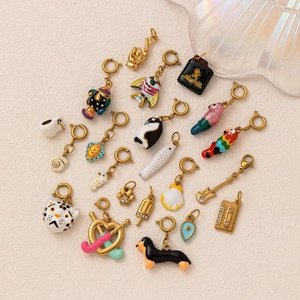 Variety of colorful enamel animal and hobby pendants in gold-plated stainless steel metal