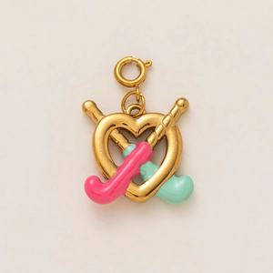 Detail of golden heart pendant with colorful enamel hockey sticks and spring clasp