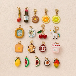 Flat lay of colorful food pendants including donuts and fruit slices on a beige background