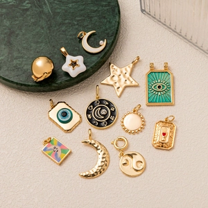 Minimalist 18K gold plated celestial charm pendants with moon star and evil eye motifs