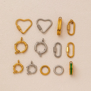 Macro view of gold and silver jewelry clasps including heart and round spring buckles