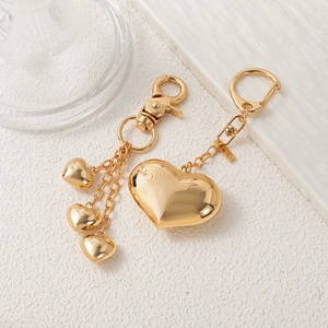 Polished gold heart-shaped metal bag charms with lobster clasp and round key rings