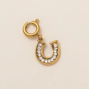 Macro shot of 18K gold plated horseshoe pendant with sparkling zircon insets