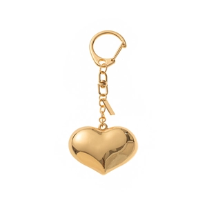 Close-up of a polished gold heart-shaped keychain with a glossy mirror finish