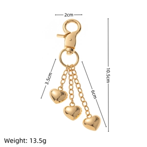 Golden heart keychain with three charms and lobster clasp shown with size dimensions