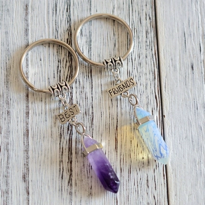 Matching Best Friends keychains with purple crystal and opal-like hexagonal pillars