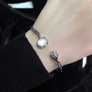 Elegant silver moonstone open bracelet with floral bud design and sparkling stone accents